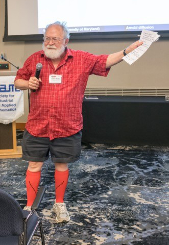 James Yorke (University of Maryland, College Park) presents five students with the famed Red Sock Award at the 2017 SIAM Conference on Applications of Dynamical Systems. Image credit: Ernie Barreto.