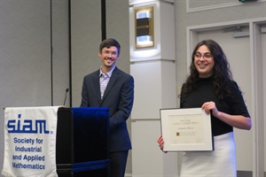 Andreea Minca, the Andrew Schultz ’36 PhD ’41 Sesquicentennial Fellow in ORIE, receives the SIAG/FME Early Career Award. At left, Mike Ludkovski, chair of SIAG/FME.