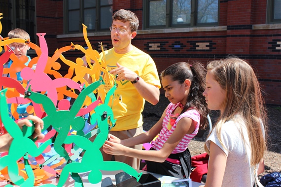 MoMath president and co-founder Glen Whitney helps young visitors explore the intricacies of the “Amazing Acrobats” exhibit. Photo courtesy of MoMath.