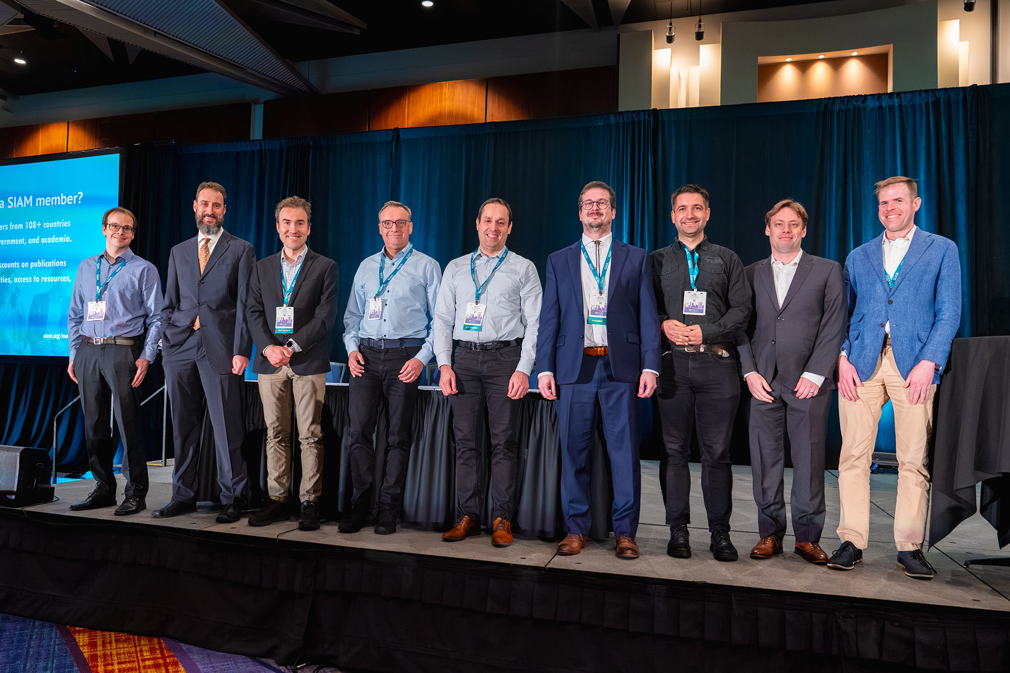 At the 2025 SIAM Conference on Computational Science and Engineering, which took place in Fort Worth, Texas, this past March, the principal authors of the deal.II project received the 2025 SIAM/ACM Prize in Computational Science and Engineering for their creation of a highly impactful library that supports finite element calculations. From left to right: Daniel Arndt of Oak Ridge National Laboratory, Wolfgang Bangerth of Colorado State University, Timo Heister of Clemson University, Guido Kanschat of Heidelberg University in Germany, Martin Kronbichler of Ruhr-Universität Bochum in Germany, Matthias Maier of Texas A&amp;M University, Peter Munch of the Technical University of Berlin, Bruno Turcksin of Oak Ridge National Laboratory, and David Wells of the University of North Carolina at Chapel Hill. Not pictured are Bruno Blais of Polytechnique Montréal in Canada, Marc Fehling of Charles University in the Czech Republic, Rene Gassmoeller of the GEOMAR Helmholtz Centre for Ocean Research Kiel in Germany, Luca Heltai of the University of Pisa in Italy, and consultant Jean-Paul Pelteret. SIAM photo.