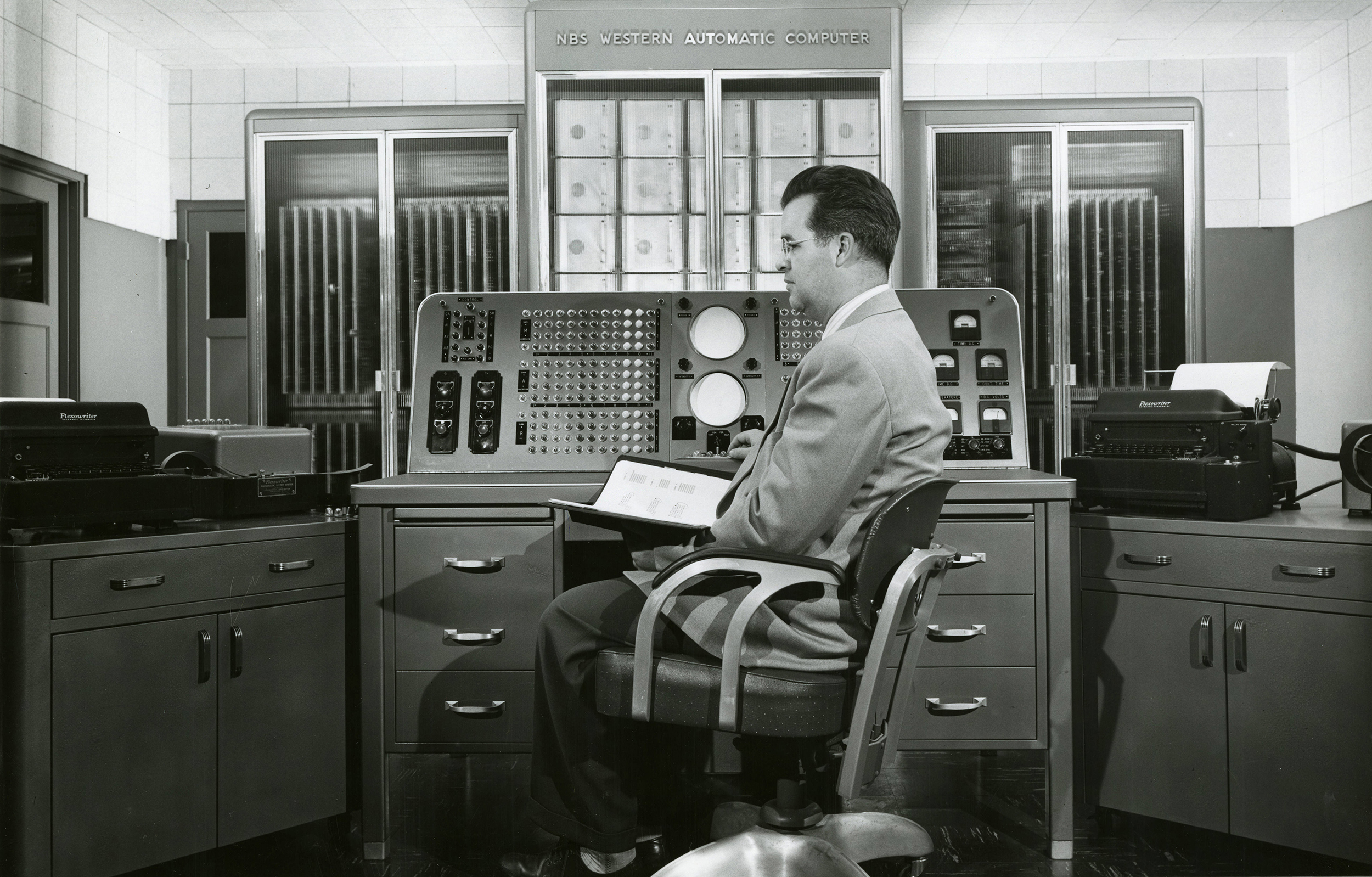 <strong>Figure 1.</strong> Harry Douglas Huskey works at the Standards Western Automatic Computer (SWAC), which he designed and constructed for the Institute for Numerical Analysis at the U.S. National Bureau of Standards. Figure courtesy of the National Institute of Standards and Technology Digital Archives, Gaithersburg, MD, 20899.