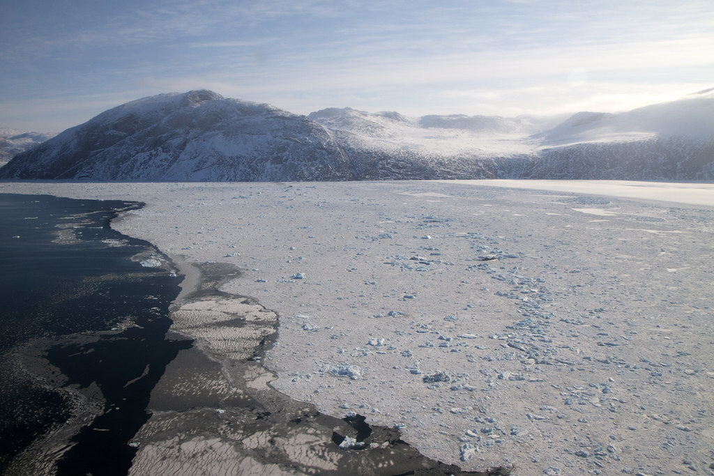 <strong>Figure 1.</strong> Sea ice off the coast of Greenland, which has been diminished by warming Arctic temperatures. The infusion of cold water into the ocean risks disrupting the Atlantic meridional overturning circulation. Public domain image courtesy of NASA.