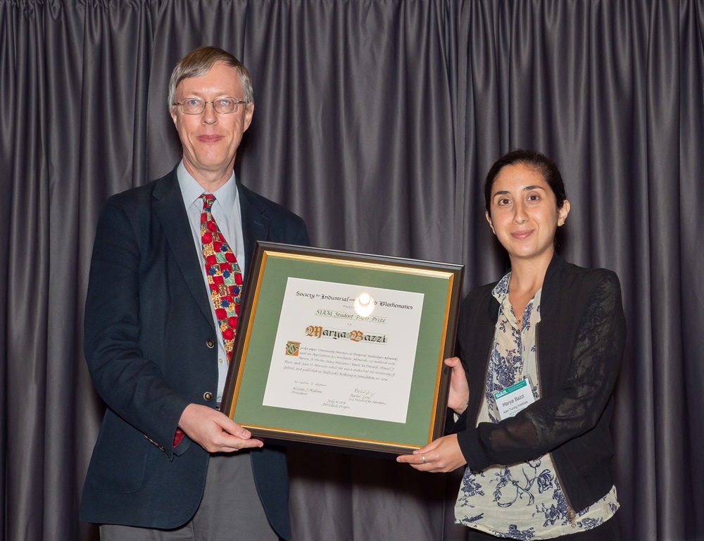 Marya Bazzi (right) received the SIAM Student Paper Prize from SIAM President Nick Higham (left) at the 2018 SIAM Annual Meeting.