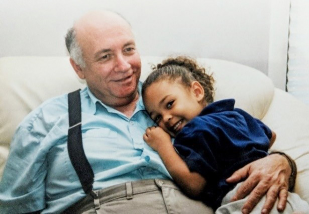Zeev Schuss (1937-2018). He is pictured here with Bob Eisenberg’s granddaughter. Image courtesy of Bob Eisenberg.