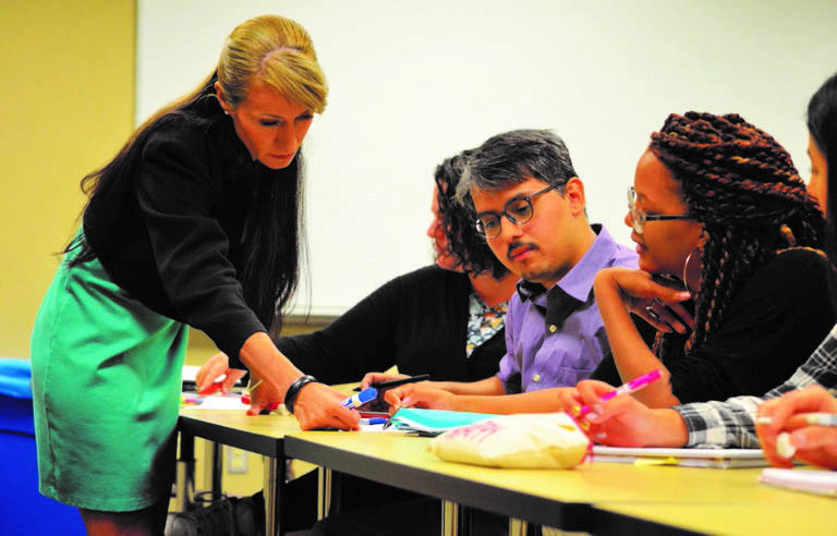 Erika Tatiana Camacho (Arizona State University and National Science Foundation)—a member of the Creating Opportunities in Mathematics through Equity and INclusion (COME-IN) working group—chats with Roberto Alvarez (middle) and Danielle Brager (right), then-students at Arizona State University. Photo courtesy of the authors.
