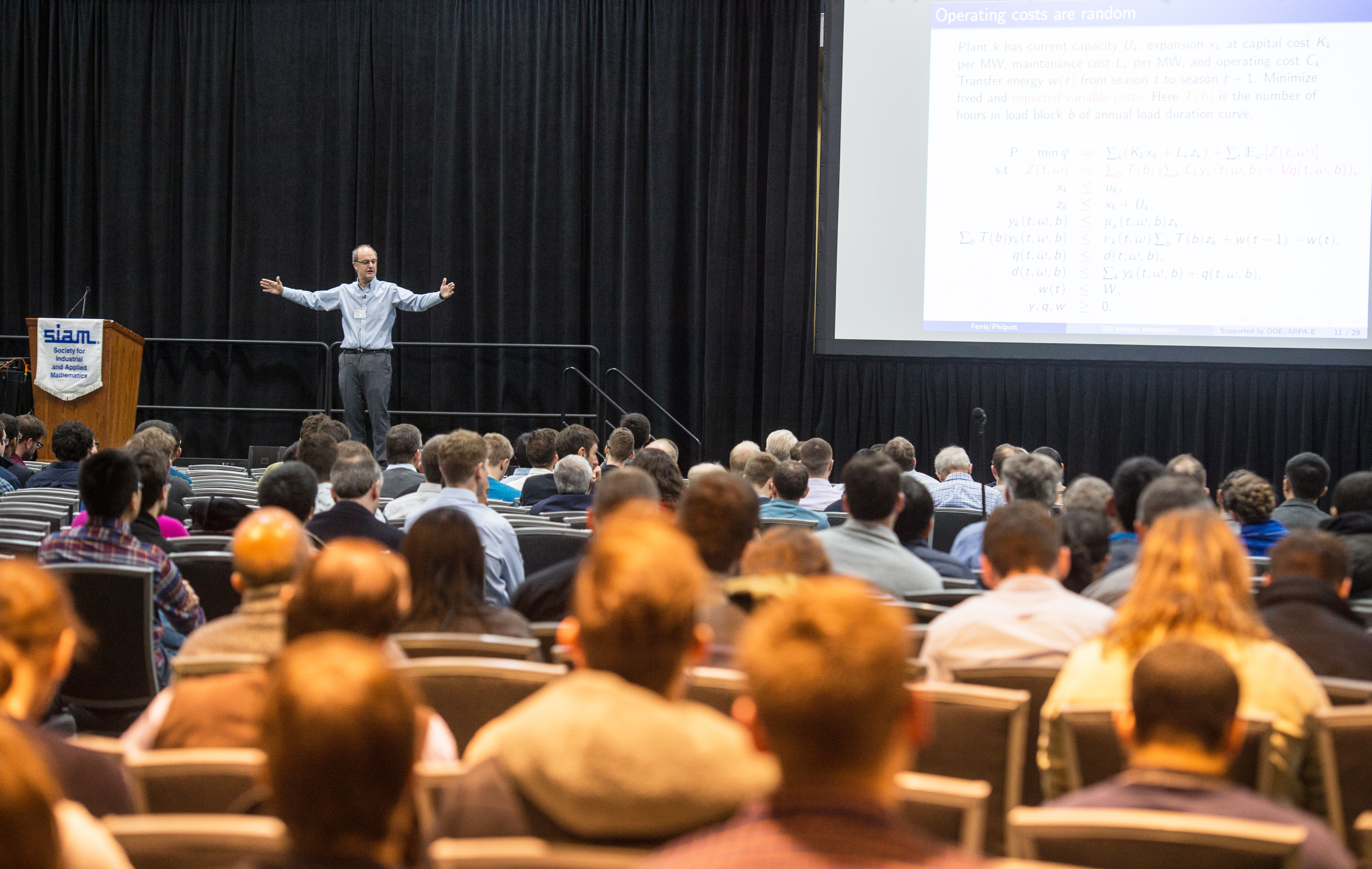 Michael Ferris of the University of Wisconsin, Madison addresses a crowded lecture hall during his invited talk on renewable electricity at the 2019 SIAM Conference on Computational Science and Engineering, which took place earlier this year in Spokane, Wash. SIAM photo.