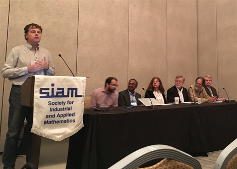 Hans De Sterck addresses attendees of the funding panel during the SIAM Conference on Computational Science and Engineering. From left to right: Youssef Marzouk (moderator), Abani Patra, Fariba Fahroo, Iain Duff, Sinnou David, and Jean-Luc Cambier Photo credit: Karthika Swamy Cohen.