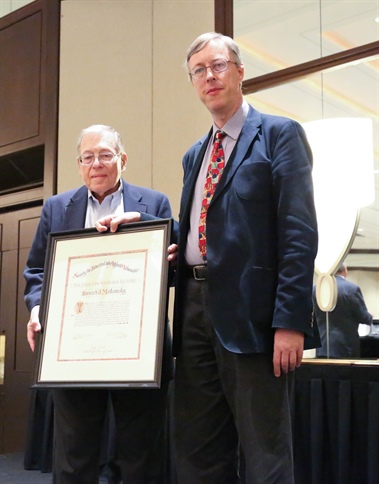 SIAM president Nicholas Higham (right) presents the 2017 John von Neumann Lecture prize to Bernard J. Matkowsky of Northwestern University.
