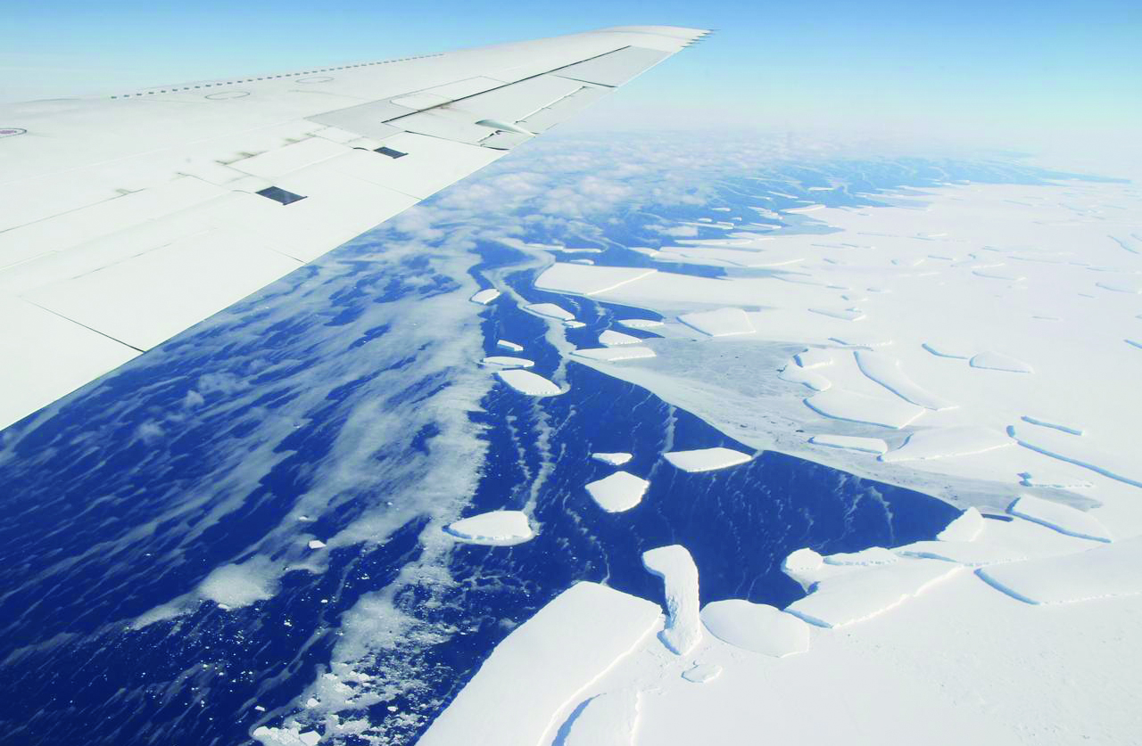 <strong>Figure 1.</strong> Aerial view of the West Antarctic ice shelf in 2012, with calving icebergs. Modeling the rate of ice loss from these types of formations requires the estimation of certain parameters that often cannot be measured directly. Photo courtesy of NASA/GSFC/Jefferson Beck.