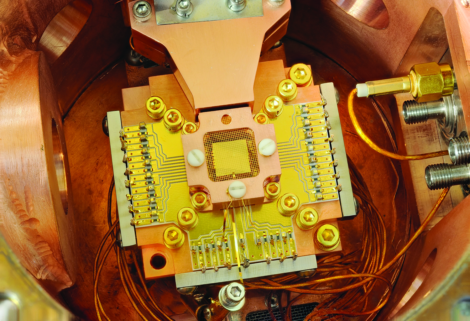 <strong>Figure 1.</strong> Ion trap devices induce the transfer of quantum information between ions to enable information processing in quantum computing. Figure courtesy of <a href="https://www.nist.gov/image/quantumcomputingiontrappingjpg" rel="noopener noreferrer" target="_blank">Y. Colombe/ National Institute of Standards and Technology</a>.