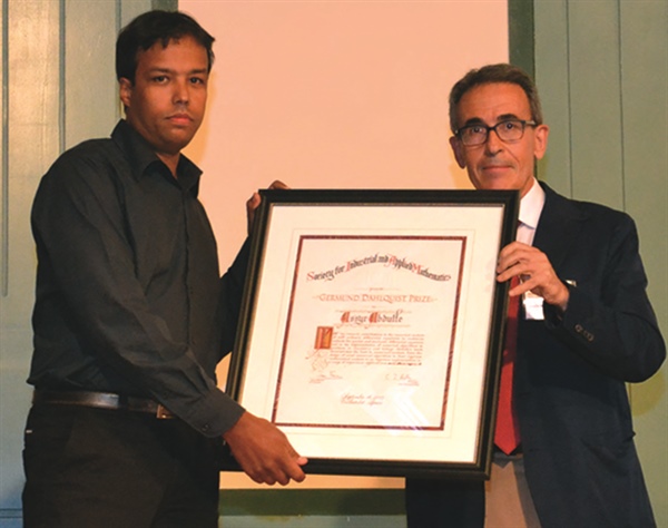 Assyr Abdulle (left) received SIAM’s 2013 Dahlquist Prize at SciCADE, in Valladolid, Spain. Awarding the prize was its first-ever recipient (1995), Chus Sanz-Serna, whose 60th birthday was also celebrated at the conference.