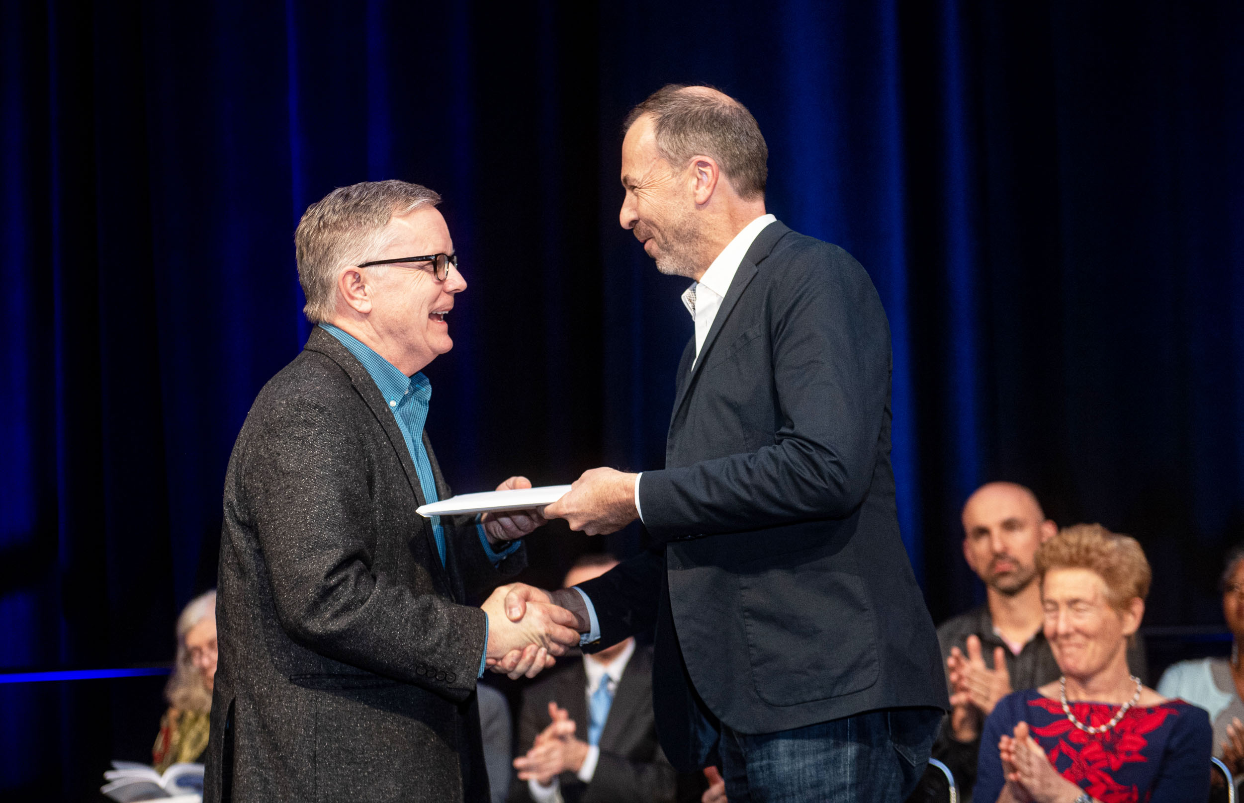 Mathematical Association of America (MAA) President Michael Dorff (left) presents the 2020 Joint Policy Board for Mathematics (JPBM) Communications Award to James Tanton. Photo courtesy of Kate Awtrey, Atlanta Convention Photography.