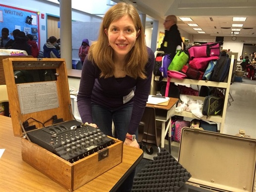 The picture is from Carla's Facebook page, posted on January 10, 2014, along with the following note: "Taught 120 fifth graders (son included) some fun math today. Even got to take a REAL Enigma machine (pictured) and taught them how to use it. I might be a math nerd, but after class one of the kids told me I was the coolest mom ever!! I'll take it! :)"