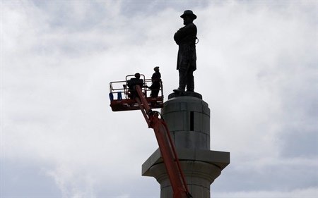 Workers prepare to take down the statue of Robert E. Lee, former general of the Confederacy, in New Orleans in May. (AP Photo/Gerald Herbert).