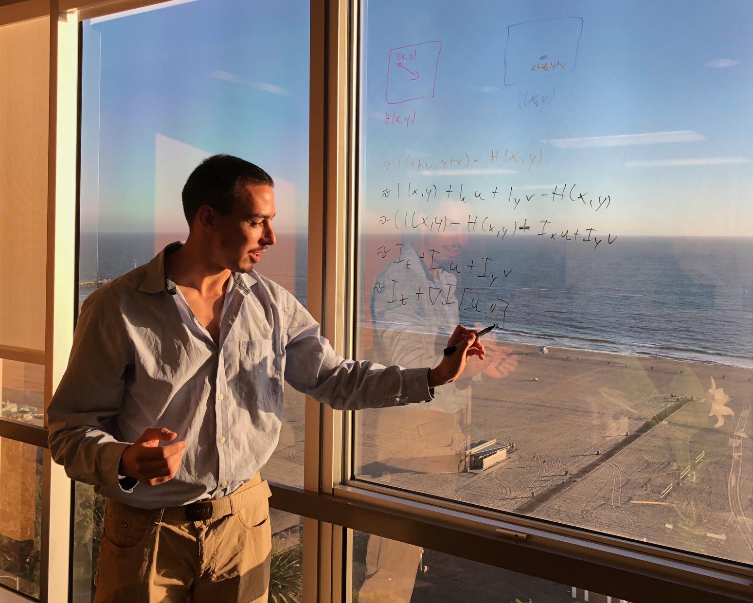 Kai Berger explains an optical flow algorithm to his group in Genius Sports Media’s Santa Monica, Calif., office. Photo credit: Pareen Kalia.