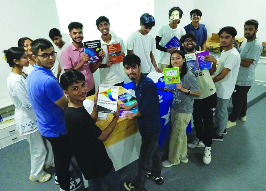 Students in EducationUSA Nepal’s Opportunity Funds Program peruse a selection of donated SIAM textbooks. Photo courtesy of Daniel Smartt.
